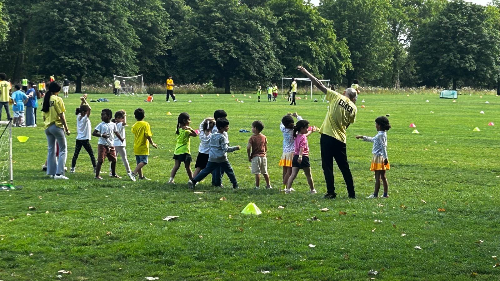 coach directing children lined up for drill