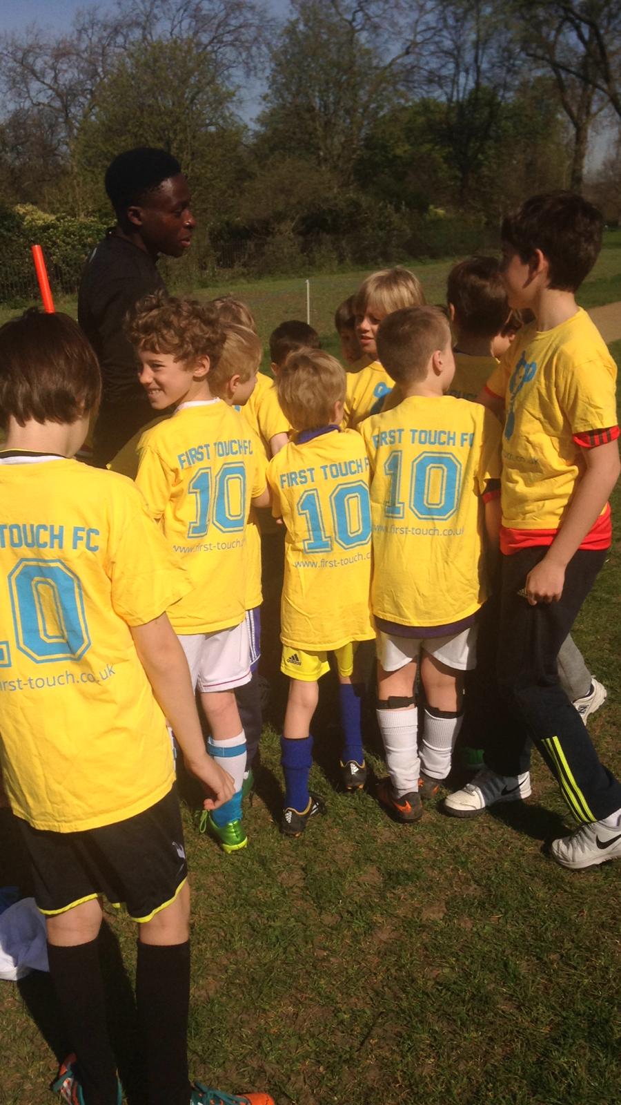 Home 14 first touch coach huddles with young players